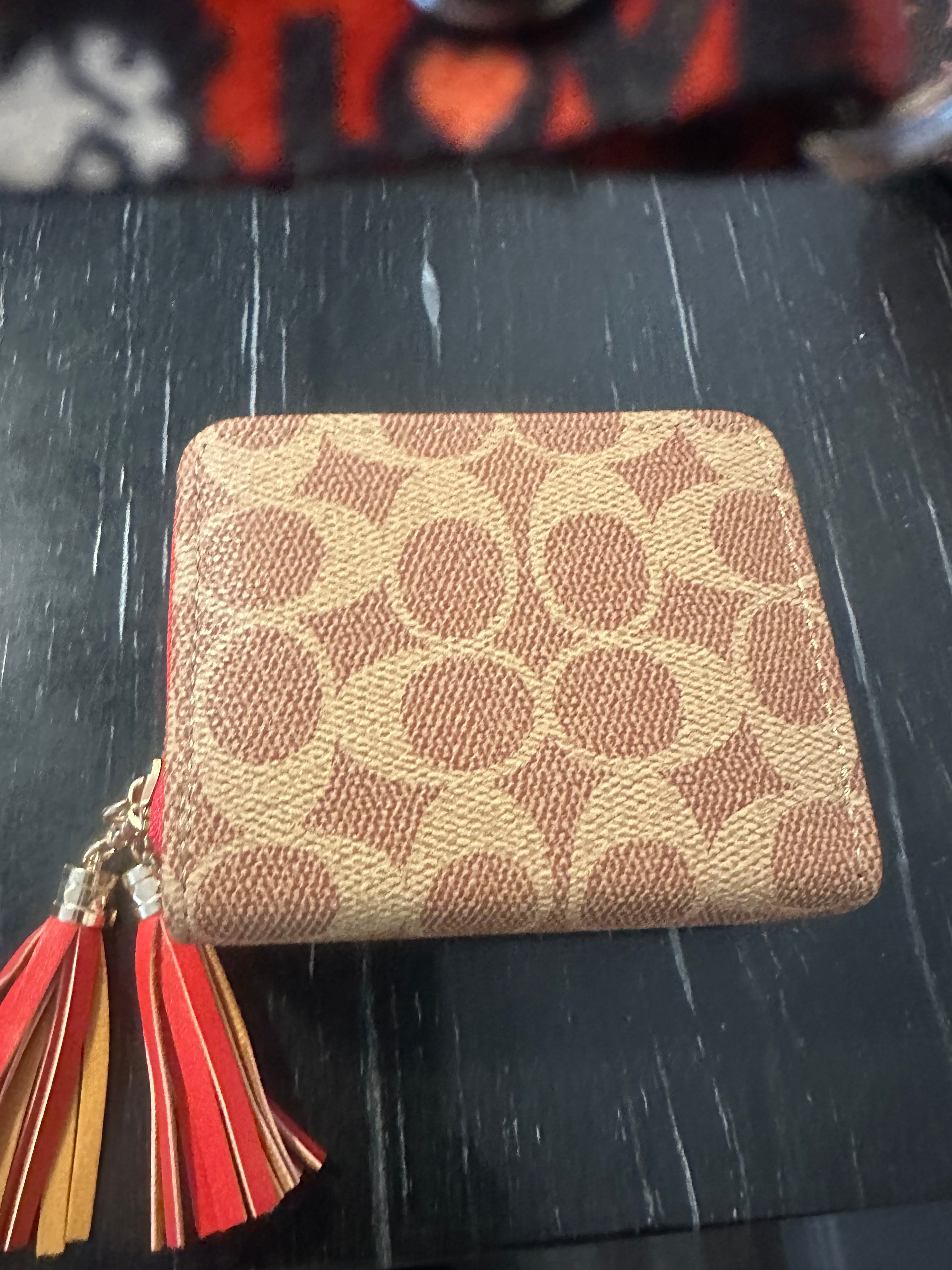 Small brown wallet with red trim